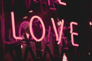 pleasepinchmehard photo from Unsplash of neon lights with the word love