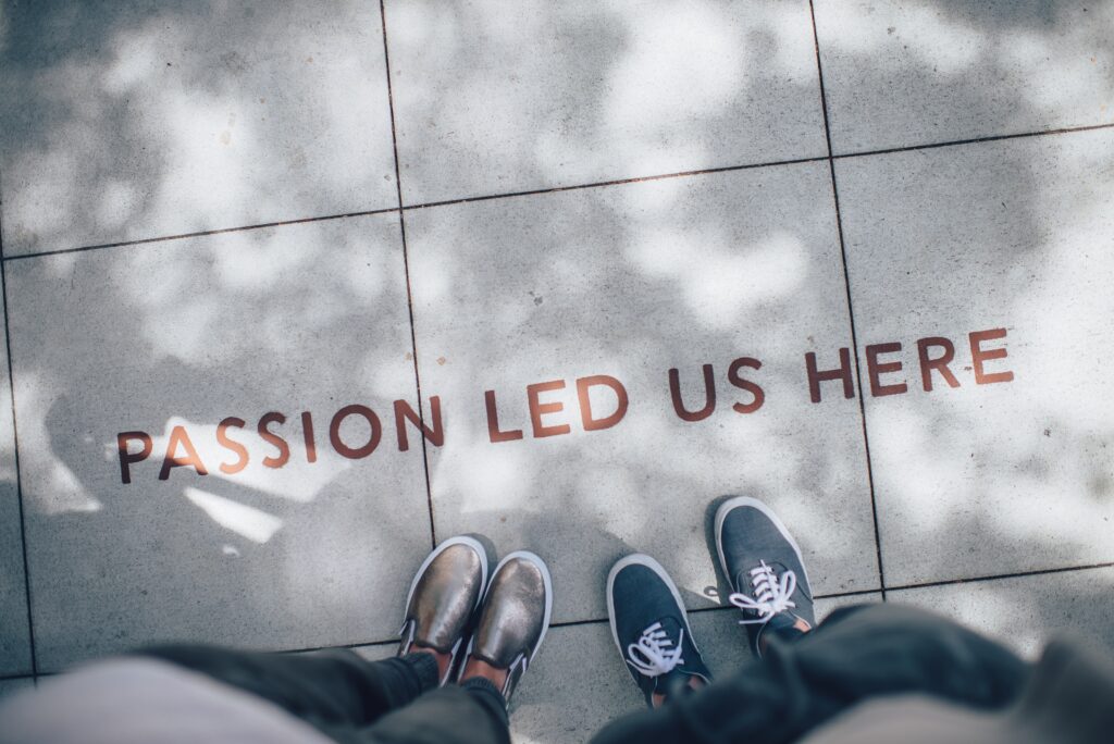 Photo of a couple standing together with the writing passion led us here for an article by Lisa Opel about open relationships and how they could save your marriage