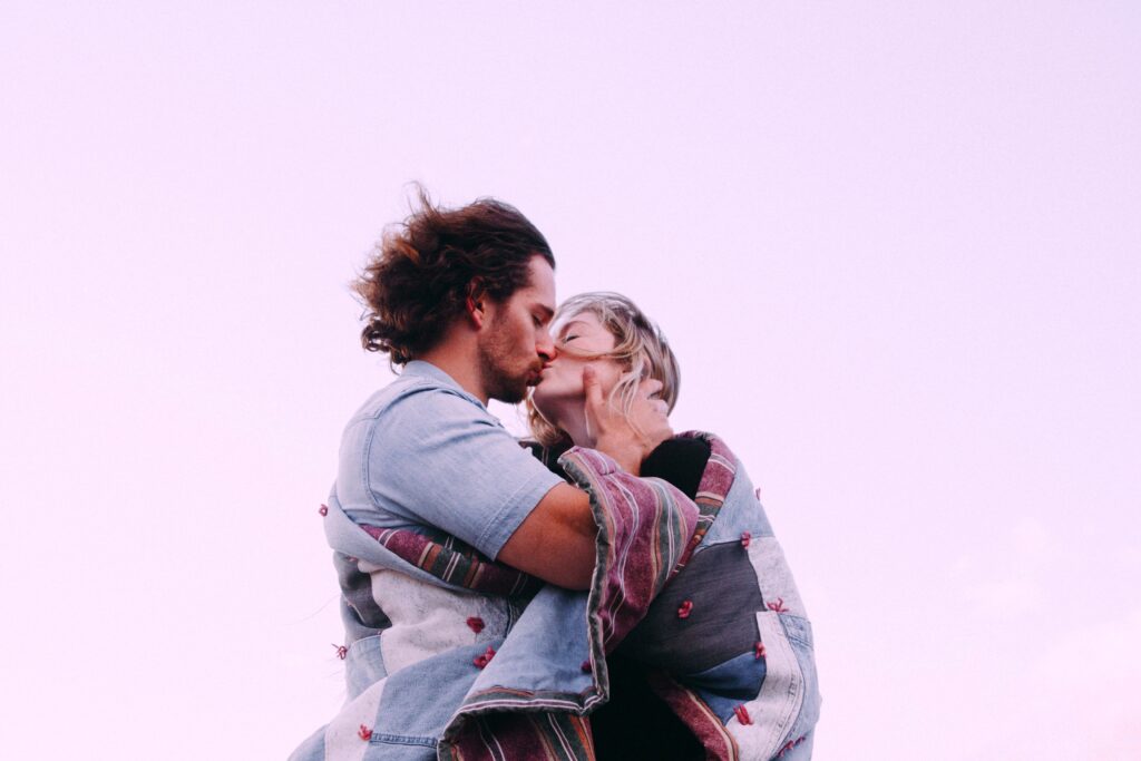 Photo of a couple kissing as an example of an intimate connection, fostered through good communication and heartfelt sentences