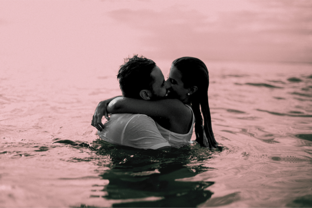 Photo of a couple kissing intimately in the sea