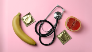 Photo of a banana and stethoscope and condom and blood orange to represent an article about Sexuality: A Guide to Professional Resources and Support