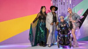 Diverse adult festival-goers in colourful goth, futuristic, western and fairy-inspired outfits with practical boots.